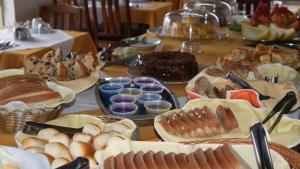 a table topped with lots of different types of food at HOTEL SÃO NICOLAU in Ubatuba