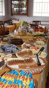 a table with many plates of food on it at HOTEL SÃO NICOLAU in Ubatuba