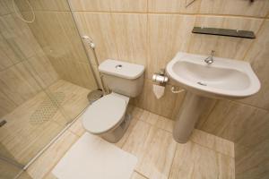 a bathroom with a toilet and a sink at Pousada Luar do Sertão in Valença