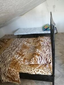 a bed in a room with a zebra print blanket at Apartment Filip in Vrbnik