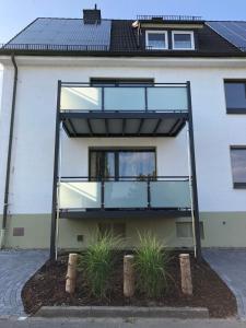 a glass house in front of a building at Ferienwohnung Tannenglück in Schmallenberg