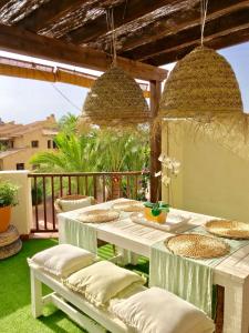 a patio with a table and chairs on a deck at Ático en Playa Altea - Puerto de Campomanes in Altea