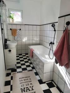 uma casa de banho com uma banheira, um WC e um lavatório. em Apartament w sąsiedztwie lasu 1800m od morza em Sopot