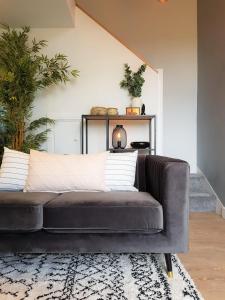 a leather couch sitting in a living room at Woodcock Farm in Glossop