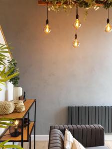 a living room with a couch and a radiator at Woodcock Farm in Glossop +40 photos
