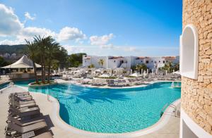 a view of a pool at a resort at Insotel Tarida Beach Resort & SPA in Cala Tarida