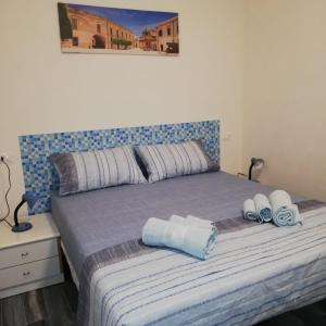 - une chambre avec un lit et des serviettes dans l'établissement TRISCINA SUMMER HOUSE, à Triscina