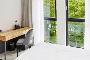 Un pat sau paturi într-o cameră la OKRA RESORT & SPA
