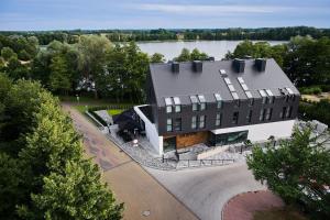 an aerial view of a building with a lake at OKRA RESORT & SPA in Drawsko Pomorskie