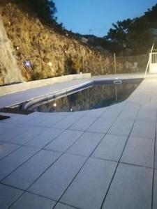 a swimming pool on the side of a building at les gites de la belle fleur in Le Gosier