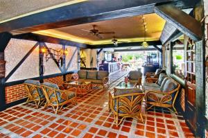 a living room with couches and chairs in a building at Stable Lodge - SHA Certified in Bangkok