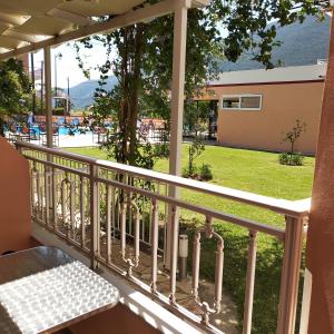 a balcony with a table and a view of a yard at Kalias Hotel in Vasiliki