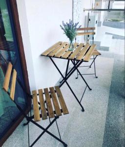 a picnic table and bench next to a building at Aviator Boutique Residence in Otopeni