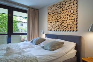 a bed with two pillows on it in a bedroom at Aba Apartamenty Piłsudskiego 41 in Krynica Zdrój