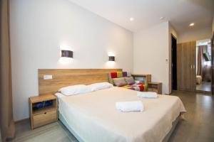 a bedroom with a large bed with two white pillows at Ef Palace Shekvetili in Shekhvetili +49 photos