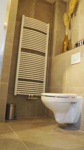 a bathroom with a white toilet and a window at Stad & Strand Appartement in Middelburg +21 photos