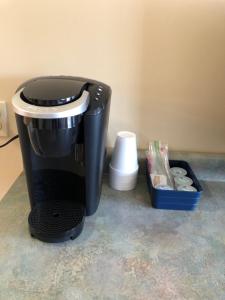 
a coffee maker sitting on top of a counter at Village Inn Motel in Chatham
