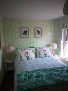 a bedroom with a bed and two pictures on the wall at Glory Days in Cromer