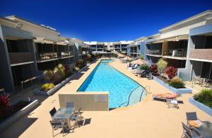 an empty swimming pool in the middle of a apartment building at Ramada by Wyndham Hervey Bay in Hervey Bay