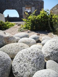 a bunch of rocks sitting on the ground at M-Vibes Mykonos Suites in Kalafatis