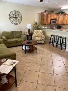 a living room with a couch and a table at Condo w Pool near beaches, dining, shopping, etc in Gulf Shores