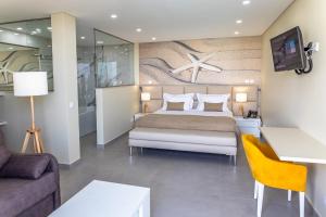 a hotel room with a bed and a couch at Lagos Atlantic Hotel in Lagos