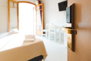 a hotel room with a bed and a door with a clock at Sisiotisa in Argostoli