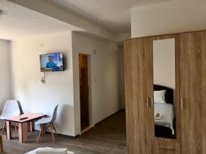 a room with a bedroom with a bed and a table at Rooms M2 in Trebinje
