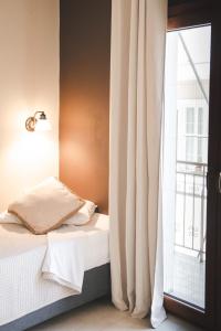 a bedroom with a bed next to a window at Sisiotisa in Argostoli