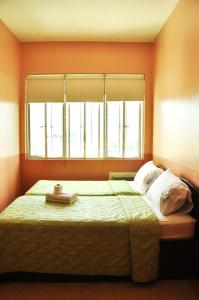 a bedroom with a large bed with a window at GV Tower Hotel in Cebu City