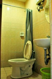 a bathroom with a toilet and a sink at GV Tower Hotel in Cebu City