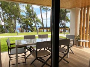 a dining room with a table and chairs at EOS Luxury Suites in Kriopigi