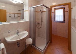 a bathroom with a shower and a sink at Panorama-Hotel am See in Neunburg vorm Wald