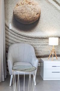a chair and a table in front of a wall at Lagos Atlantic Hotel in Lagos