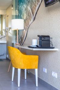 a yellow chair sitting on top of a wooden table at Lagos Atlantic Hotel in Lagos