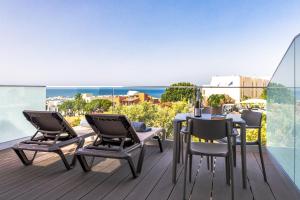 a patio with a table and chairs on a balcony at Lagos Atlantic Hotel in Lagos