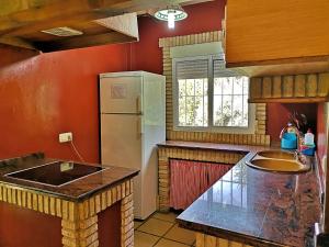 a kitchen with a refrigerator and a counter top at Casa el Rincon Cazorla in Burunchel