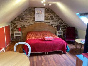 a bedroom with a large bed in a attic at Moulin des Baleines de Kérandraon Plouguerneau in Plouguerneau