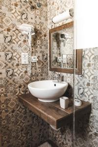 a bathroom with a sink and a mirror at Sisiotisa in Argostoli