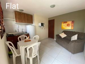 a living room with a couch and a table and chairs at Muriú Beach Flat in Muriú