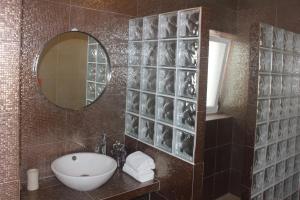 a bathroom with a sink and a mirror at Casinha da Andorinha - Ericeira in Ericeira +27 photos