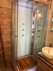 a glass shower in a bathroom with a sink at casa la valle in San Fedele Intelvi