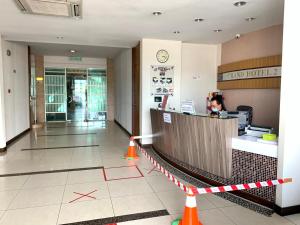 a lobby of a hotel with a counter and a woman at Grand Hotel 2 in Keningau