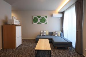 a living room with a couch and a table at Koti Sopo Universal Bay 2 by Liaison in Osaka