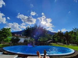 a person with their feet up in a swimming pool at Falgerhof in Vollan