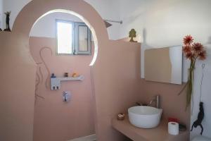 a bathroom with a sink and a toilet and a window at Pefkos Eye in Pefki Rhodes