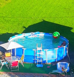 an overhead view of a pool with chairs and a ball at U Białasów in Małe Ciche