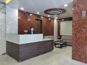 a man wearing a face mask in a lobby at Hotel Sarvin in Lucknow