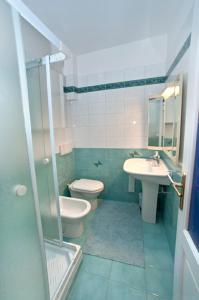 a bathroom with a sink and a toilet and a sink at Bed and breakfast Grim in Trieste