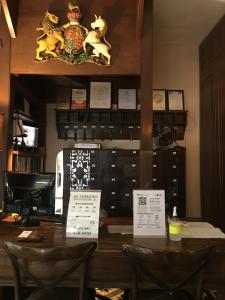 a table with two chairs in a restaurant with signs on it at Campbell House in George Town